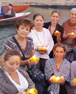 Travel Astu Mexican group offering flowers to holy river Ganga